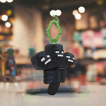 Load image into Gallery viewer, Minecraft 5 Inch Wither Bag Hanger Plush with pixelated design and clip-on attachment in a store setting.