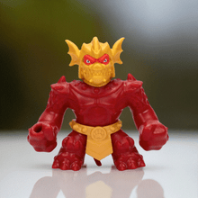 Load image into Gallery viewer, Goo Jit Zu Stretch Strikers Blazagon toy with fiery design on white surface.