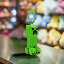 Load image into Gallery viewer, Minecraft 5 Inch Creeper Bag Hanger Plush with a pixelated design on display.