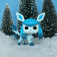 Load image into Gallery viewer, Glaceon Pokemon POP! Vinyl figure amidst snowy trees.