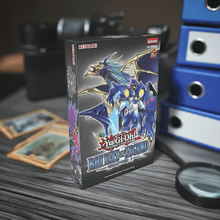 Load image into Gallery viewer, Yu-Gi-Oh! Battles of Legend Chapter 1 set on a table with cards and collectibles.
