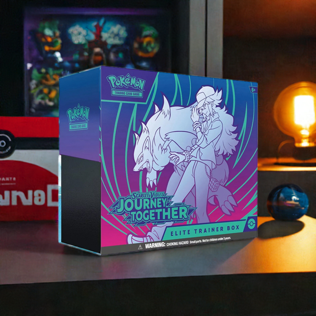 Pokemon TCG Journey Together Elite Trainer Box on table, surrounded by gaming decor.