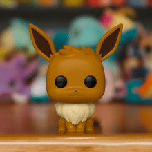 Load image into Gallery viewer, Eevee Pokemon POP! Vinyl Figure on display, showcasing cute details and playful pose.
