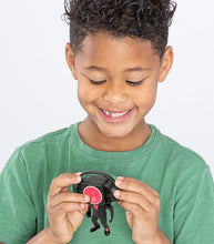 Load image into Gallery viewer, Child delightedly holding a Skibidi Toilet Mystery Mini Figure from Series 1 collection.