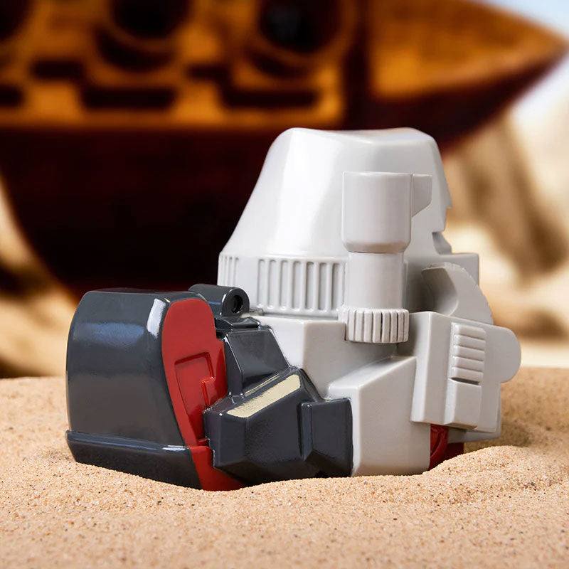 TUBBZ Transformers Megatron Collectible Duck on sandy surface with detailed black and red design, fusion cannon visible.