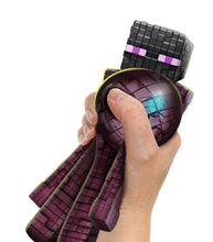 Load image into Gallery viewer, Stretchy Heroes of Goo Jit Zu Minecraft Enderman toy in hand, showcasing pixelated design and goo-filled squishiness.

