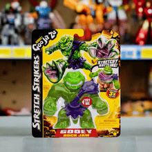 Load image into Gallery viewer, Heroes of Goo Jit Zu Stretch Strikers Rock Jaw action figure in packaging, showcasing stretchy and gooey features.
