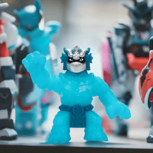 Load image into Gallery viewer, Heroes of Goo Jit Zu Stretch Strikers Pantaro toy figure in vibrant blue, showcasing its stretchable and gooey features among other action figures.

