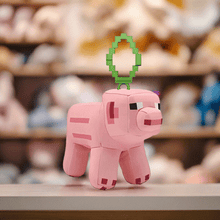 Load image into Gallery viewer, Minecraft 5 Inch Pig Bag Hanger Plush with clip attachment and authentic pixelated design on display.

