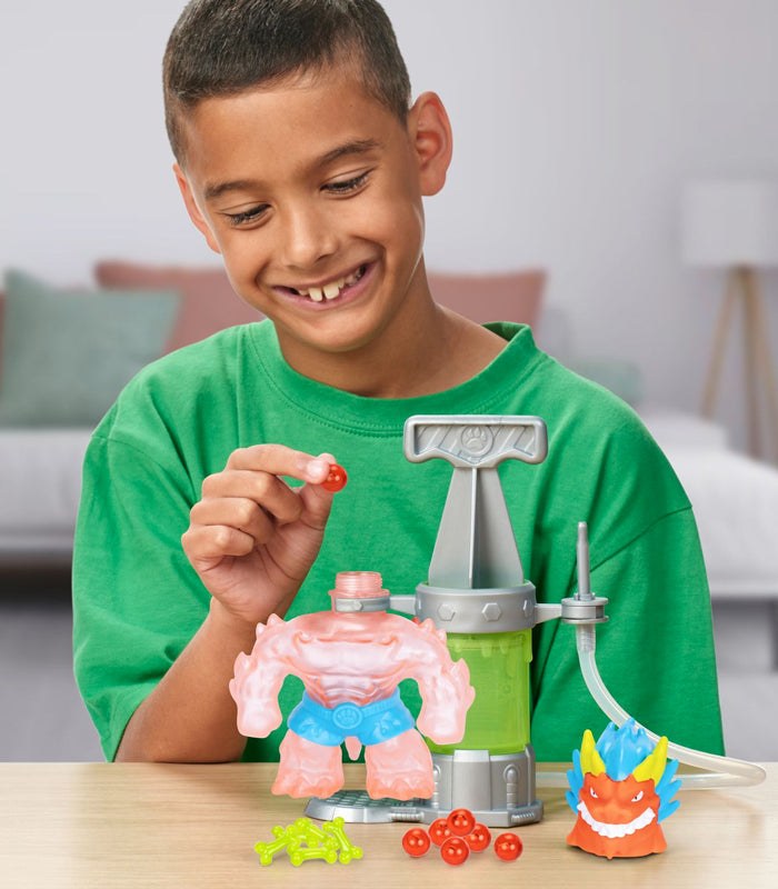 Heroes of Goo Jit Zu Hero Creator Blazagon kit with child assembling custom figure.