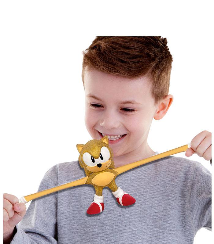 Child playing with Stretch Armstrong Gold Sonic the Hedgehog toy, showing its stretchy and durable features.