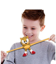 Load image into Gallery viewer, Child playing with Stretch Armstrong Gold Sonic the Hedgehog toy, showing its stretchy and durable features.
