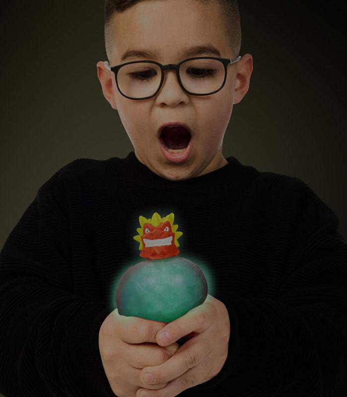 Child amazed by glowing Blazagon from Goo Jit Zu Glow Shifters toy.