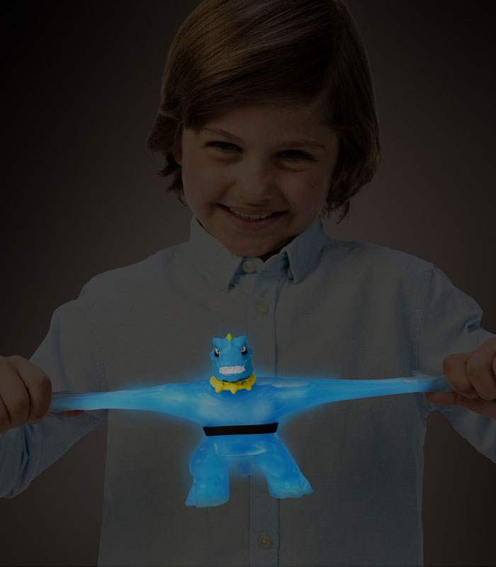 Goo Jit Zu Glow Shifters Tyro toy glowing in the dark, being stretched by a child.