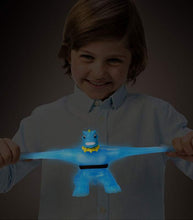 Load image into Gallery viewer, Goo Jit Zu Glow Shifters Tyro toy glowing in the dark, being stretched by a child.
