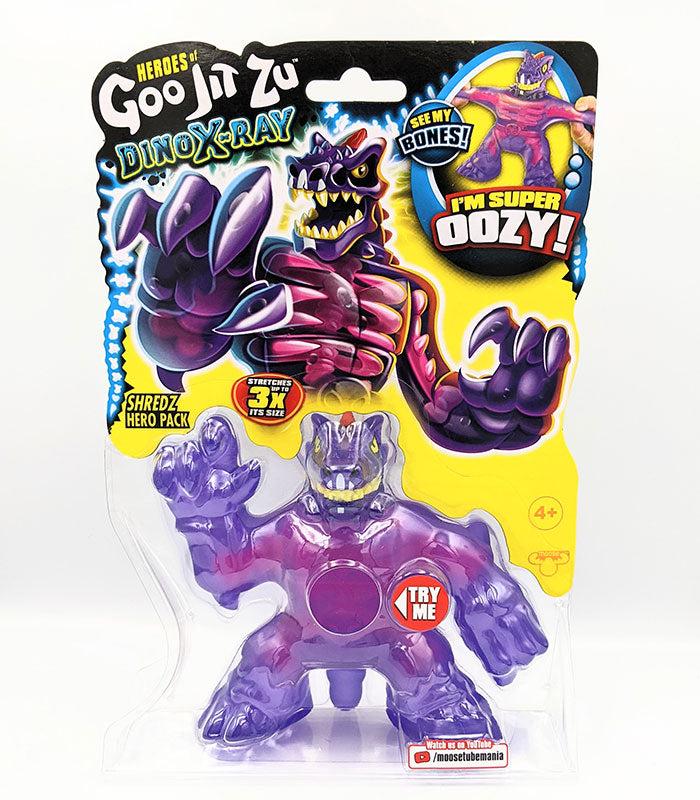Heroes of Goo Jit Zu Dino X-Ray Shredz toy in packaging showing dinosaur character with stretchable features and bones reveal.