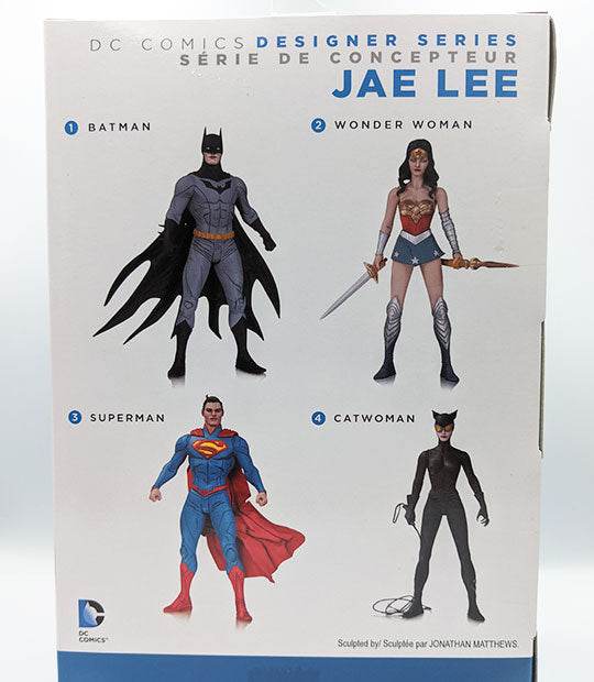 DC Comics JAE Lee Designer Series 1 Superman action figure packaging, featuring detailed designs of Superman, Batman, Wonder Woman, and Catwoman.