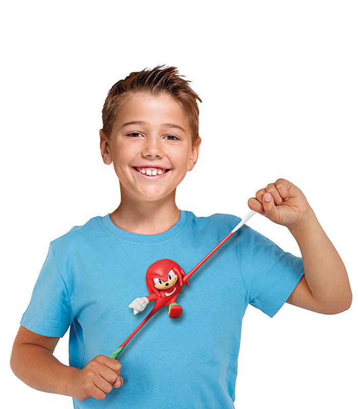 Stretch Armstrong Knuckles toy being stretched by a smiling child.