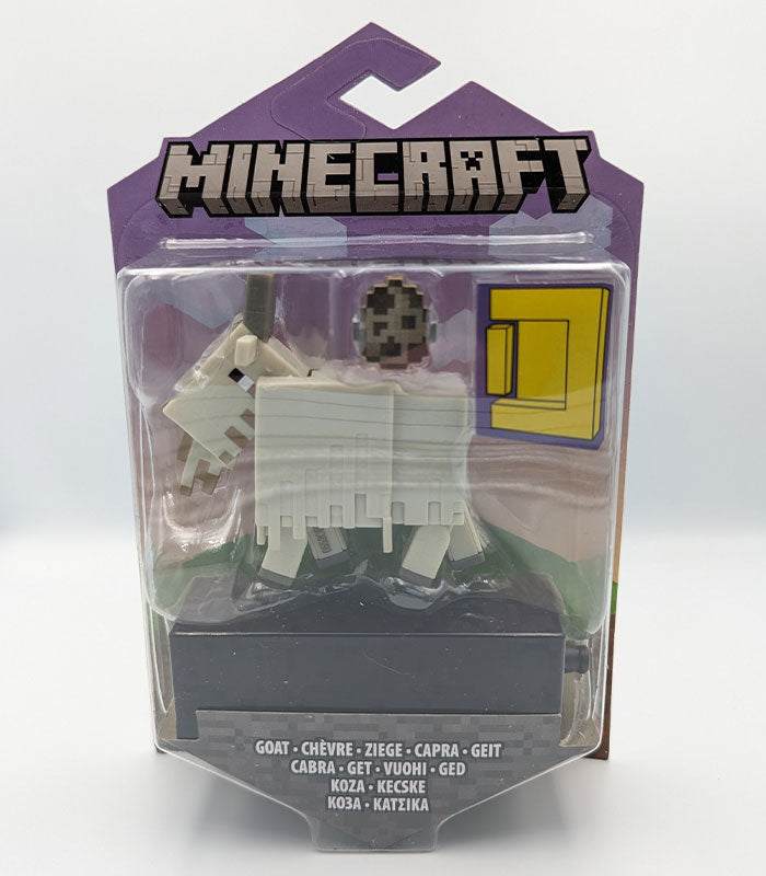 Minecraft Portal Action Figure - Goat in packaging with accessories, suitable for ages 3 and up.