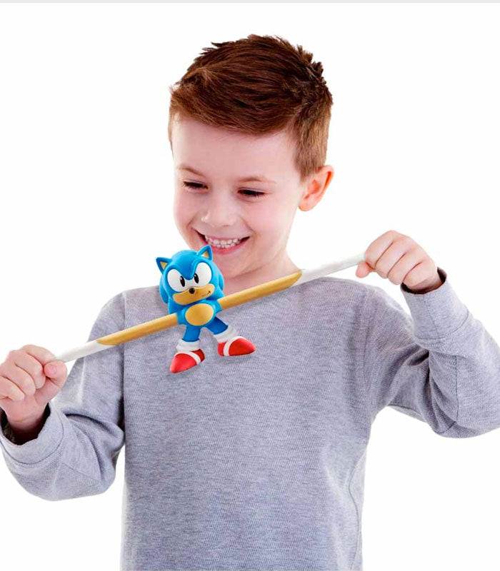 Child playing with Stretch Armstrong Sonic the Hedgehog toy, stretching it to showcase its elasticity and durability.