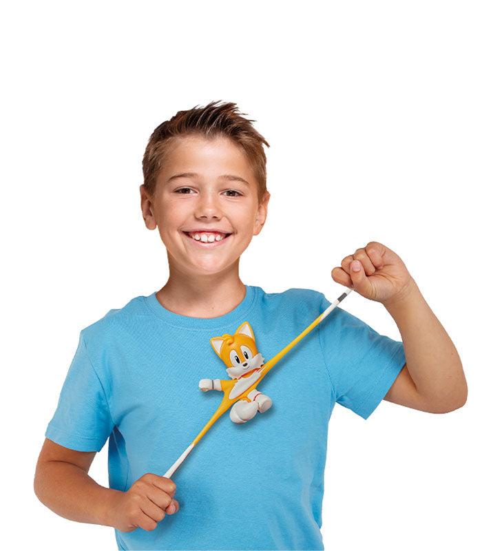 Boy playing with Stretch Armstrong Tails toy.