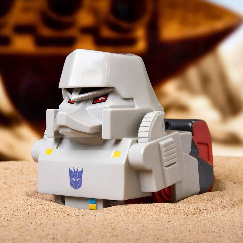 TUBBZ Transformers Megatron Collectible Duck in desert setting, featuring signature black and red colors, face mask, and fusion cannon.